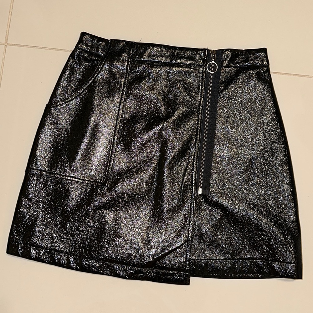 Black mini skirt with side pocket and zipper.
